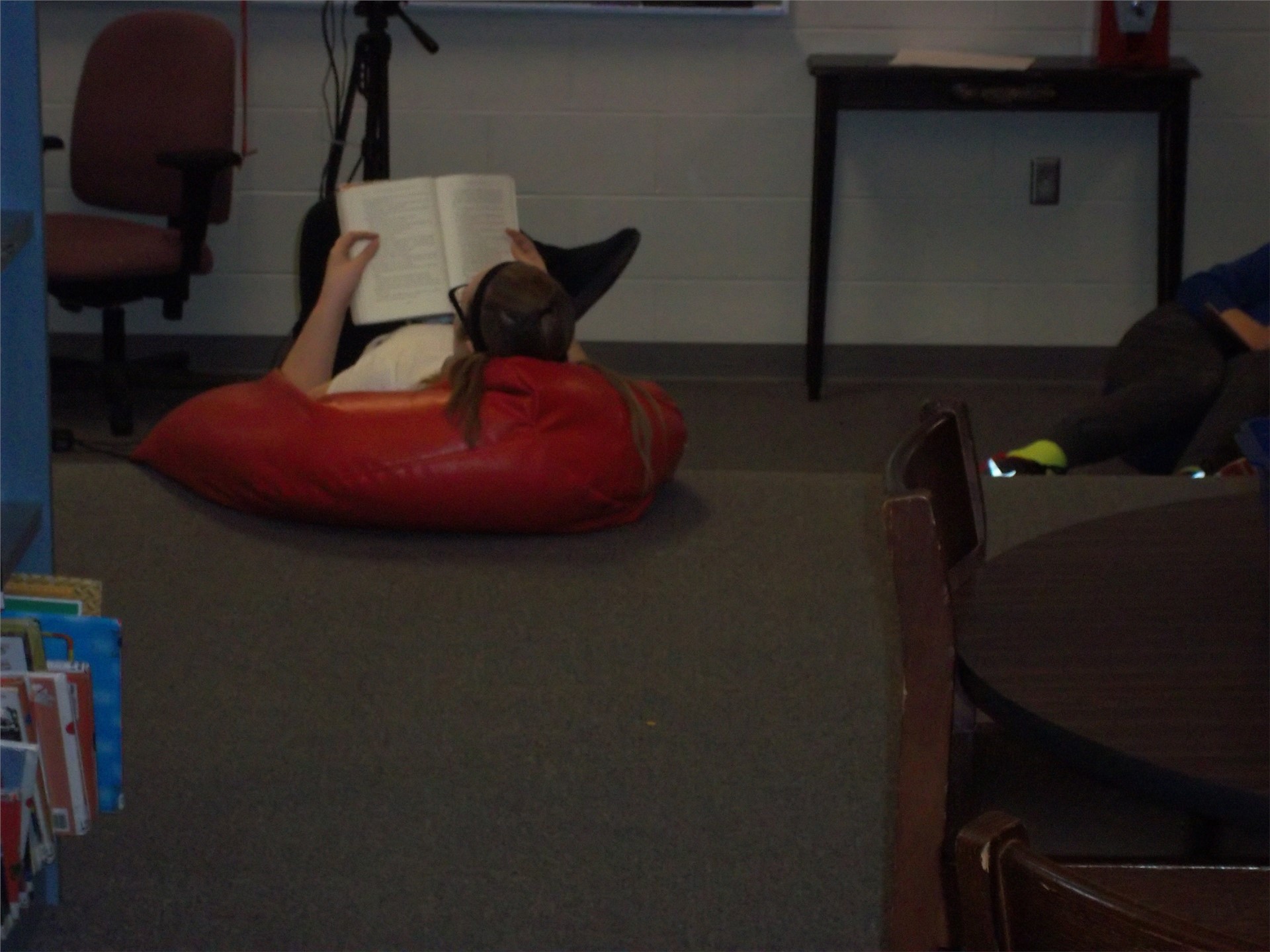 Student reading in bean bag chair.
